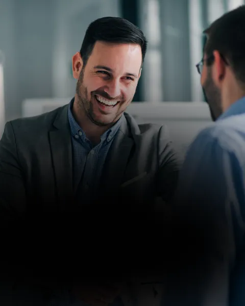 Smiling man in suit engaged in conversation